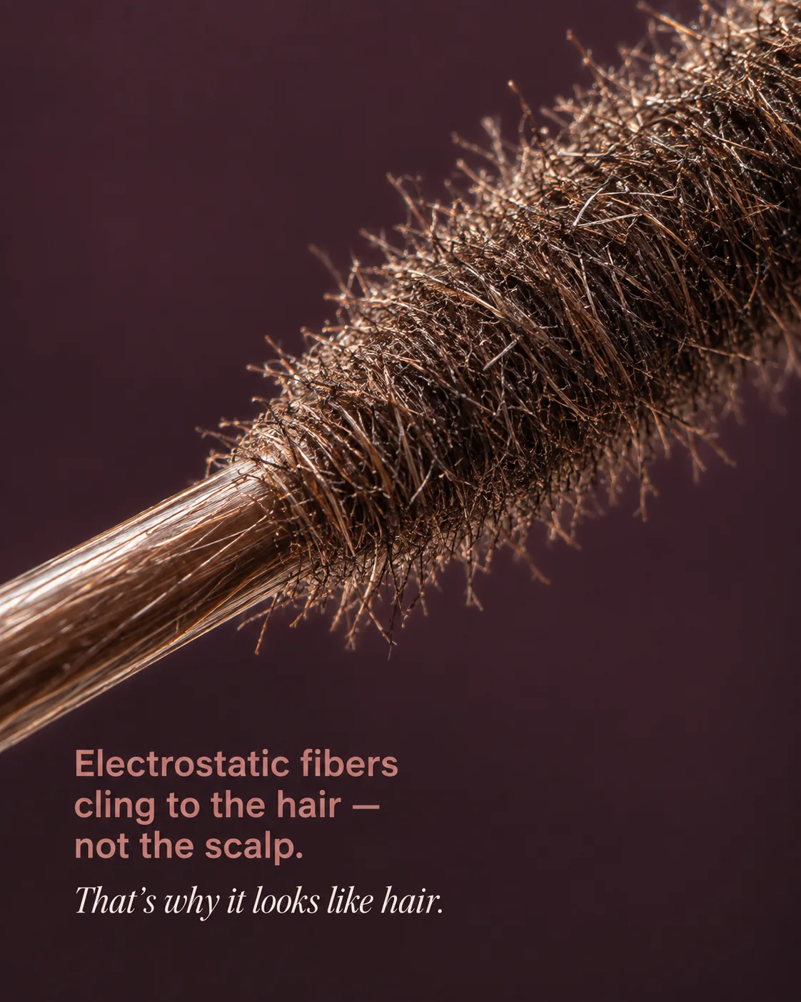 Macro illustration of electrostatic StrandVeil fibers clinging around an existing hair strand